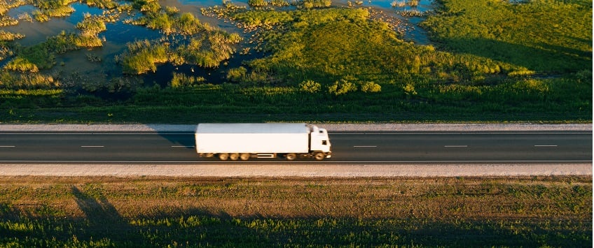 european cargo truck driving on a scenic road